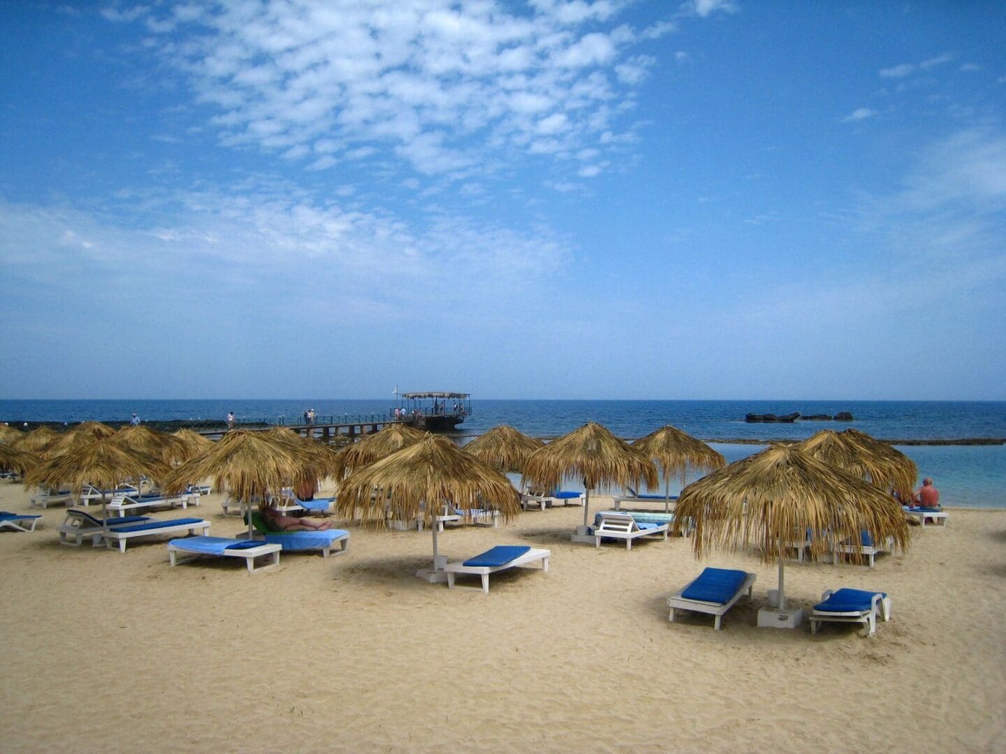 fm=f_116081 A beach with many chairs and umbrellas on it